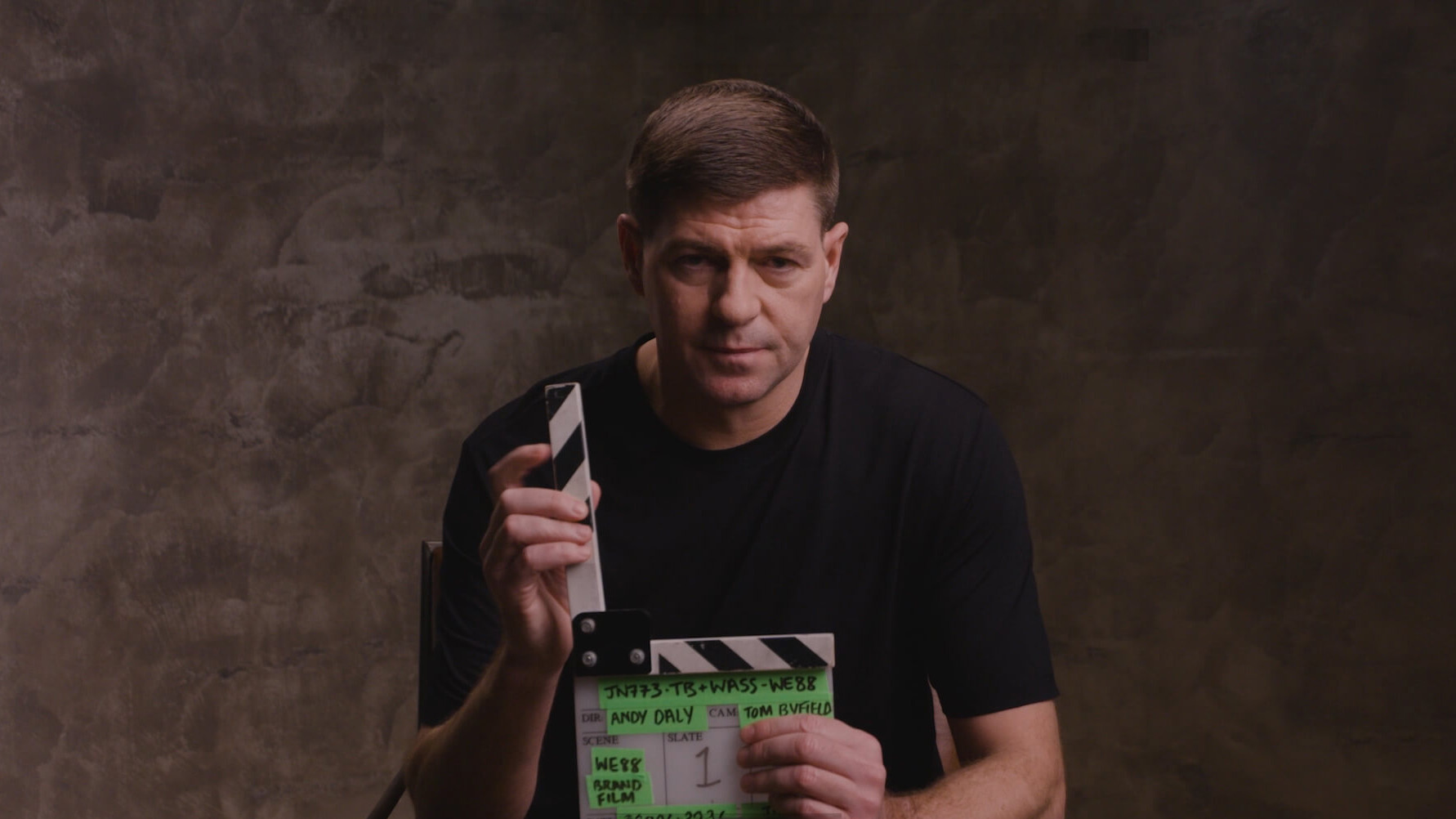 WE88 26/27 Global Brand Ambassador Steven Gerrard holding a production clapperboard on set for the official brand film